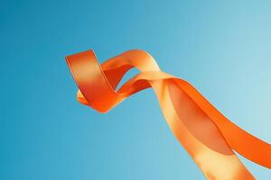 Orange ribbon flowing against a blue sky photo