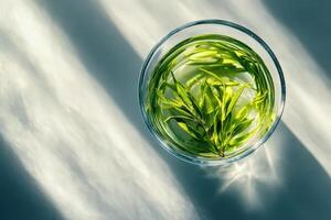Glass of fresh green herbal tea leaves photo