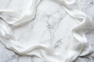 White Silk Ribbon Arranged on Marble Background photo
