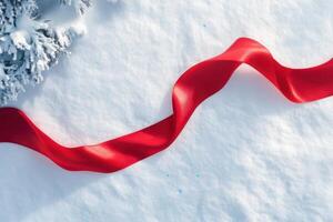 Red ribbon on snowy ground near winter tree photo