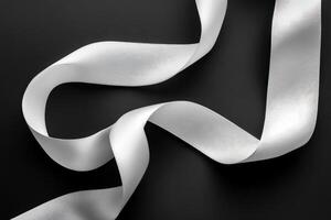 Elegant White Ribbon Curls on Black Background photo