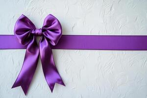 Purple Satin Bow and Ribbon on White Textured Background photo