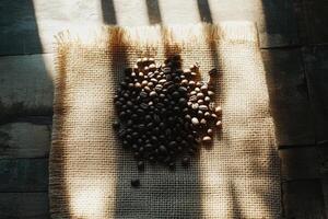 Sunlit Coffee Beans Resting on Burlap Fabric photo