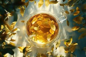 Golden Tea Leaves Infused In Glass Cup Surrounded By Autumn Leaves photo