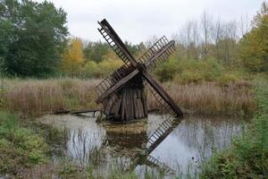 A windmill in the middle of a pond photo