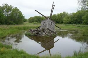 A windmill in a pond photo
