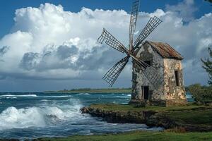 A windmill on the shore of the ocean photo