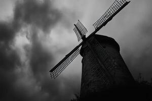 A black and white photo of a windmill