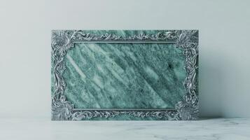 A green marble frame with ornate design photo