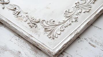A white frame with ornate designs on it photo