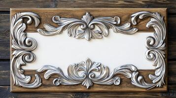 A wooden frame with silver decorative design photo