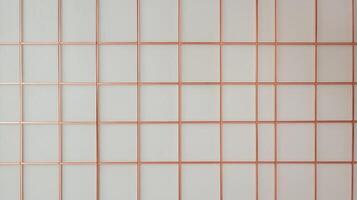 A white wall with copper wire mesh photo
