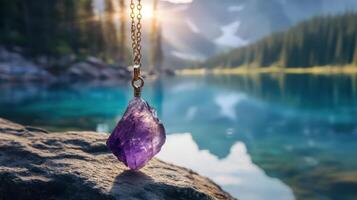 Amethyst crystal on a rock by a lake photo