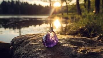 Amethyst crystal on a rock by a lake photo