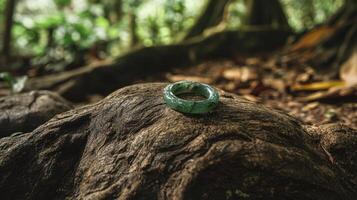A green ring sitting on top of a rock in the woods photo
