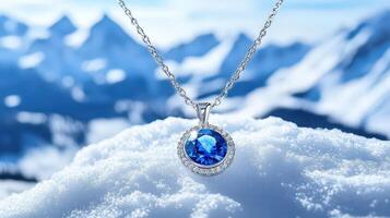 A blue sapphire pendant on top of a snowy mountain photo