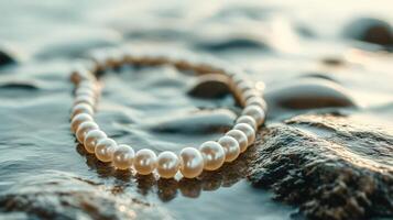 A pearl necklace laying on the rocks photo