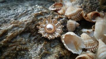 A pearl and gold pendant sitting on top of some shells photo