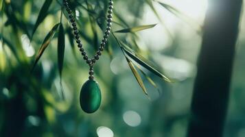 A green stone is hanging from a chain photo