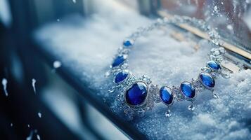 A blue necklace is sitting on a window sill photo