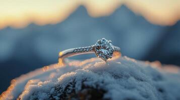 An engagement ring sits on top of a mountain photo
