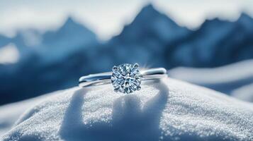 A diamond ring sitting on top of a mountain photo