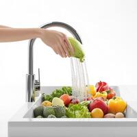 A person is washing vegetables in a sink photo