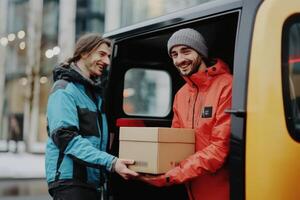 Delivery man receives package from courier outside urban building photo
