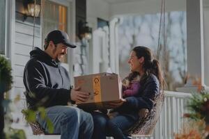 Happy couple receiving package on porch swing photo