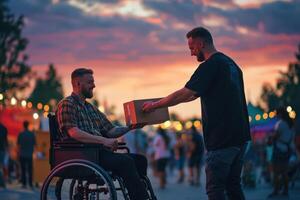 Man in wheelchair receives package from another man at sunset photo