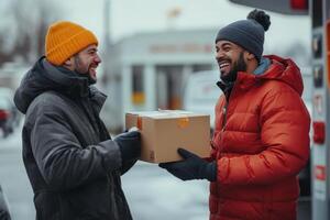 Happy men exchanging a package outside in winter photo