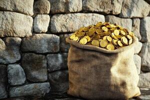 A bag full of gold coins sitting on a stone wall photo