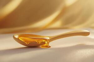 Honey on a wooden spoon on a table with golden light background photo