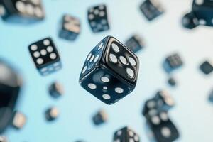 Black Dice Falling Against A Light Blue Background photo