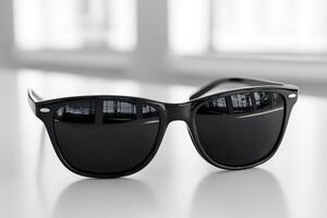 A pair of black sunglasses on a table photo