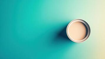Beige Paint in a Metal Can on Teal Background photo