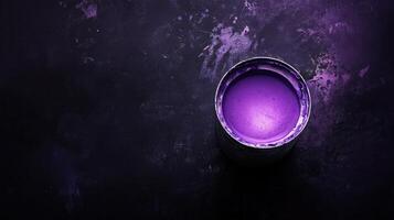 A purple paint can on a dark background photo