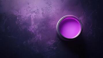 A vibrant purple paint sits on a dark textured surface photo