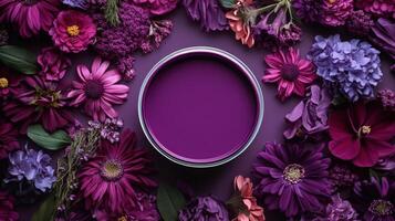 Purple flowers and a round paint can on a purple background photo