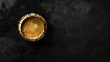 Golden paint in a metallic container on black background photo