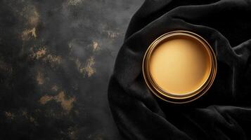 Gold circular frame on black velvet fabric background photo