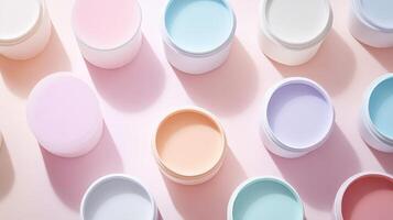 Pastel Colored Cream Jars Arranged On Pink Background photo