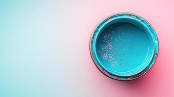 Teal Paint Can With Glitter On Pink Background photo