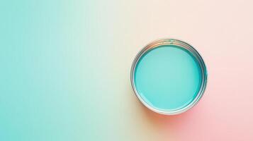 A Can of Teal Paint Sits on a Pastel Background photo