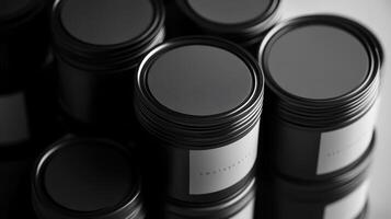 Stacked black paint cans with labels photo