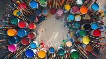 Colorful Paint Cans and Brushes Arranged Artistically photo