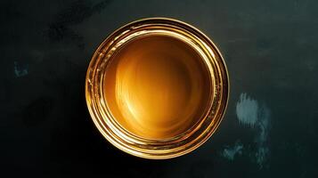 Golden Oval Container Holds Amber Liquid photo