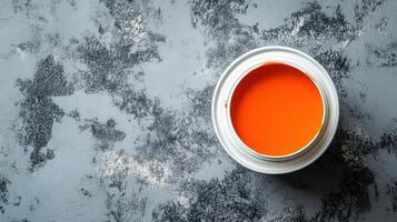 Orange Paint in a Can on a Gray Surface photo