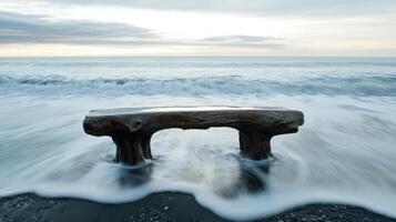 Wooden Bench Stands on Beach Amidst Rolling Waves photo