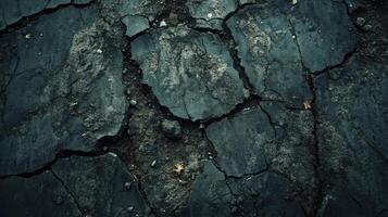 A close up of a cracked black surface photo